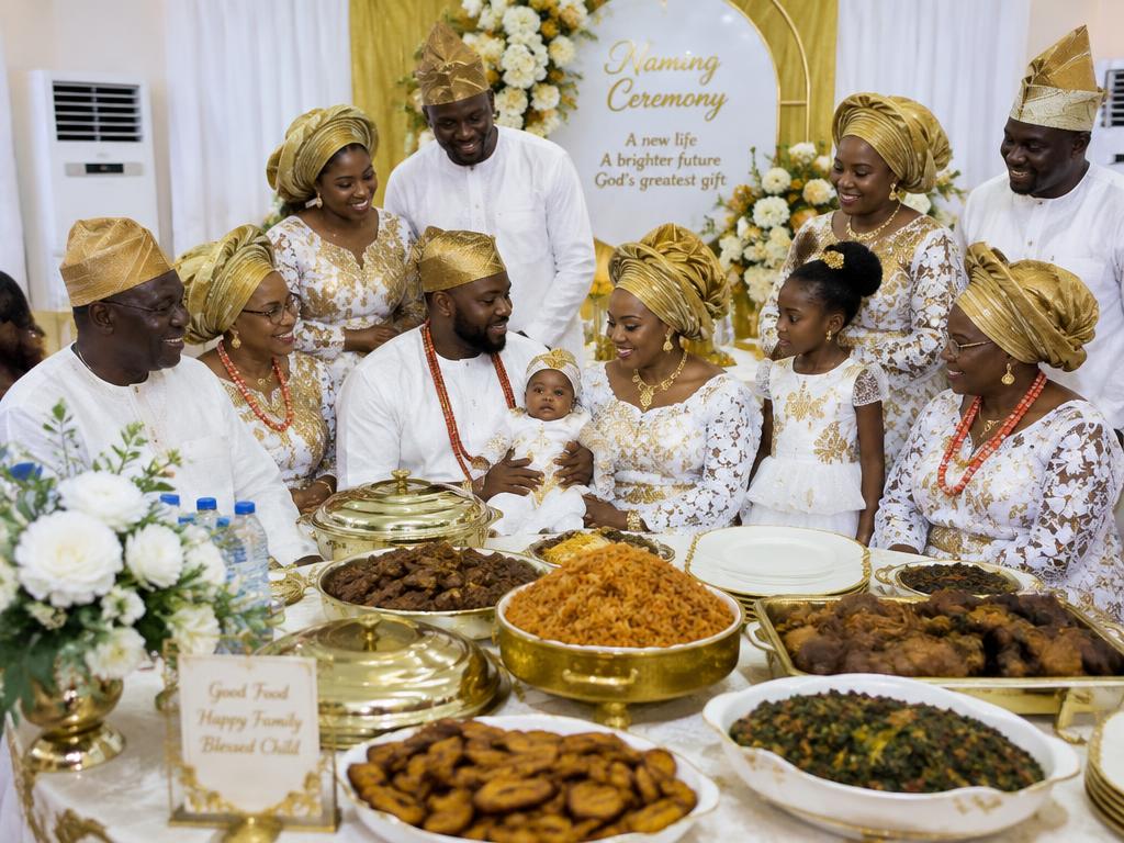 Family gathered around a naming ceremony food spread